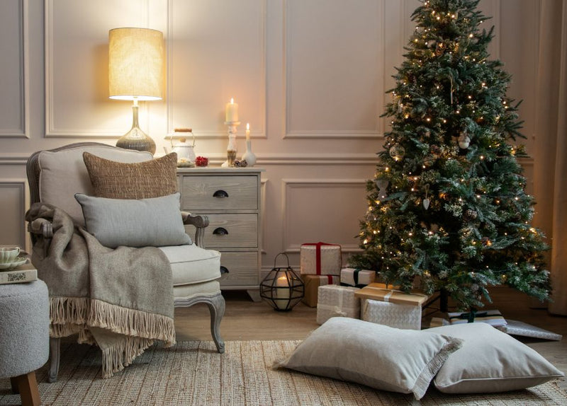 A living room featuring a festive tree and a range of luxury Christmas decorations.