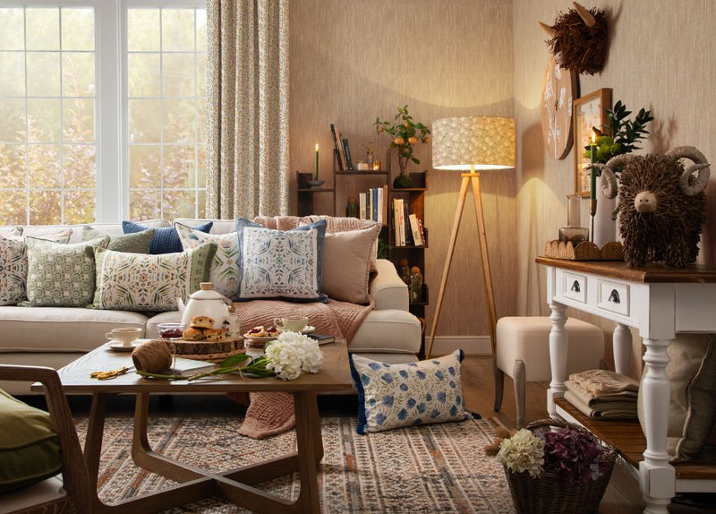 A country-style living room decorated with a highland cow sculpture among other furniture pieces and soft furnishings.